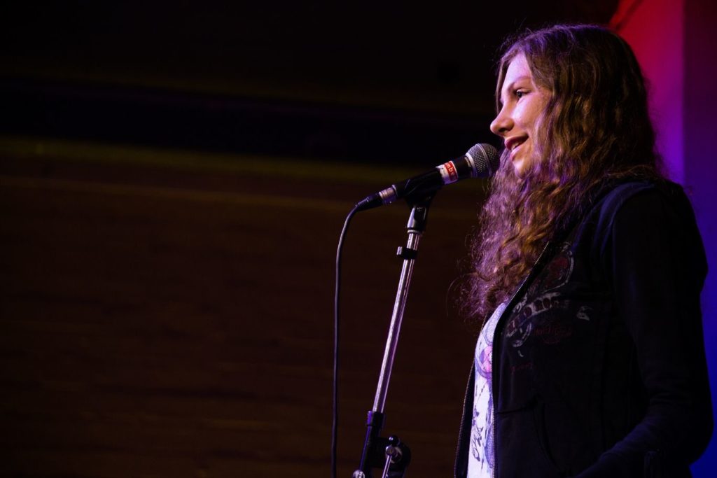 Poetry Slammerin Jamie auf der Bühne in Vorrunde 1 der Essener Stadtmeisterschaften 2019 - Titelbild zu "beim Poetry Slam mitmachen"